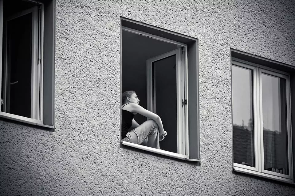 black and white woman in a window